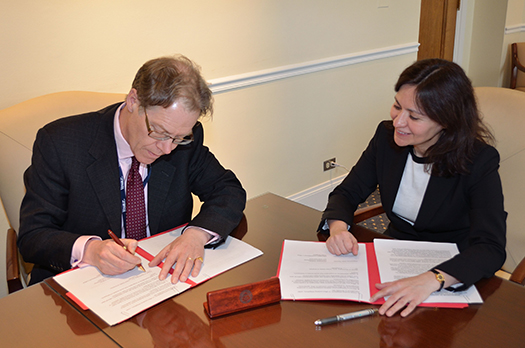 FTC Chairwoman and UK Information Commissioner seated at a table signing the memo