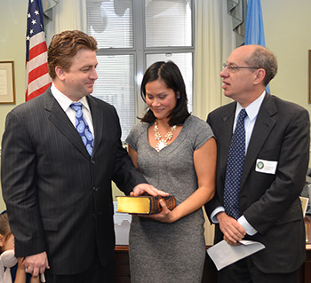 FTC Commissioner Joshua Wright with his wife, Anhvinh Wright, and FTC Chairman Jon Leibowitz
